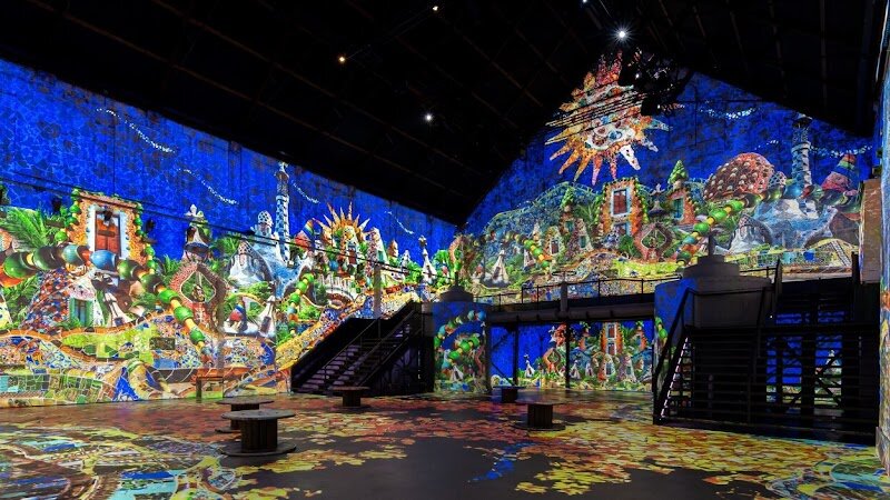 Fabrique des Lumières - Fabrique des Lumières invites families and curious travelers to step into a mesmerizing world where art comes alive in breathtaking light and sound. Housed in the historic Westergasfabriek, a former gasworks built in 1883 to illuminate Amsterdam’s streets, this vast industrial space has been transformed into the city’s largest digital art center. Its towering 17-meter walls now serve as canvases for immersive exhibitions that surround visitors with animated masterpieces—from Klimt’s golden swirls to the vibrant colors of Van Gogh and the surreal visions of Dalí. What makes Fabrique des Lumières truly special is its innovative fusion of history and technology. As you wander through the expansive halls, you’re not just looking at art—you’re enveloped in it, with projections that move across floors, ceilings, and walls, accompanied by evocative soundtracks. Shows change throughout the year, so every visit offers something new, whether it’s celebrating Dutch Masters or exploring cosmic themes. This is a place where imaginations run wild, children are captivated, and adults rediscover wonder—a modern museum experience designed to thrill all ages in the heart of Amsterdam’s cultural landscape.