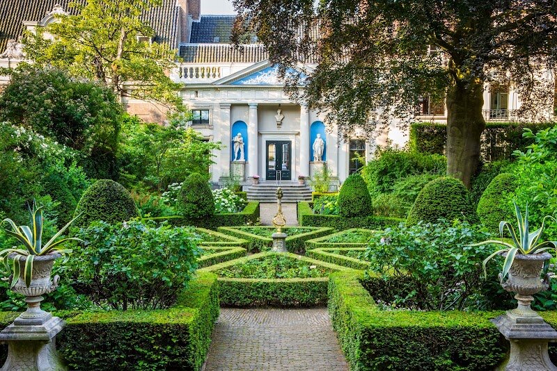 Museum Van Loon - Museum Van Loon offers a rare journey into Amsterdam’s aristocratic past, nestled along the city’s picturesque Keizersgracht canal. Housed in a grand 17th-century canal mansion designed by Adriaen Dortsman, this museum brings to life the elegance and stories of the influential Van Loon family, whose legacy is woven into the fabric of Dutch history—Willem van Loon was even a co-founder of the Dutch East India Company. Inside, families and curious travelers can wander through lavishly decorated rooms filled with centuries-old portraits, gleaming silver, fine porcelain, and exquisite furniture, all carefully preserved to reflect the opulent lifestyle of Amsterdam’s Golden Age. Children and adults alike will be captivated by tales of the house’s first resident, the artist Ferdinand Bol, a pupil of Rembrandt, and by the playful details like painted fake doors and hidden corners. Beyond the interiors, a stroll through the tranquil 17th-century garden—complete with a charming coach house—offers a peaceful escape and a glimpse into the private world of Amsterdam’s elite. With its authentic atmosphere, rich history, and engaging exhibits, Museum Van Loon is a delightful destination for anyone eager to step back in time and discover the stories behind Amsterdam’s grand canal houses.
