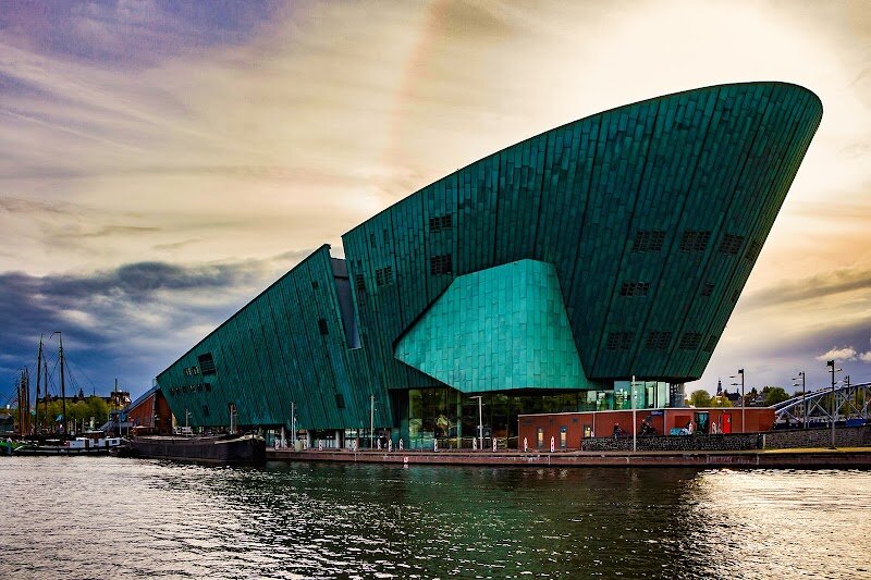 NEMO Science Museum - NEMO Science Museum is Amsterdam’s ultimate playground for curious minds, where science springs to life through hands-on discovery. Housed in a striking, ship-shaped building designed by renowned architect Renzo Piano, NEMO rises above the city’s harbor—an architectural nod to Amsterdam’s seafaring past and its spirit of innovation. With a legacy stretching back to 1923, NEMO has evolved from a humble labor museum into the Netherlands’ largest science center, welcoming hundreds of thousands of visitors each year. Inside, five dynamic floors brim with interactive exhibits: launch a chain reaction with giant dominoes, unravel the mysteries of DNA, or experiment in the bustling science lab. Kids and adults alike can explore the wonders of electricity, test their senses, and even oversee a mini ball factory in action. Beyond the exhibits, the panoramic rooftop terrace offers sweeping views of Amsterdam—a perfect spot to reflect on discoveries made within. NEMO’s mission is clear: to ignite curiosity and inspire all ages to explore the marvels of science and technology. For families and inquisitive travelers, NEMO promises an unforgettable adventure where learning and fun go hand in hand.