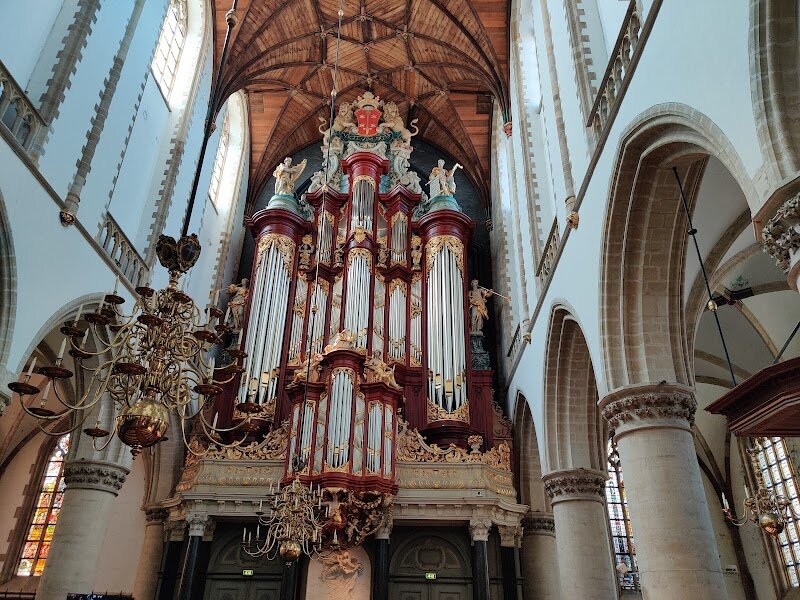 The St. Bavo Church in Haarlem - Standing proudly in the heart of Haarlem, the **St. Bavo Church (Grote Kerk)** is a masterpiece of late Gothic architecture and a true icon of Dutch history. Dating back to the 13th century, this towering church has witnessed centuries of dramatic change—from its medieval Catholic origins to its transformation during the Reformation, and its enduring role as a community landmark. Families and curious travelers alike are drawn to its soaring spire, the intricate wooden vaulting overhead, and a sense of grandeur that echoes through every stone. Inside, visitors are captivated by the legendary **Christian Müller organ**, once the largest in the world and famously played by both Handel and Mozart. Children and adults can marvel at the artistic treasures, from historic paintings to ornate carvings, while the church’s vast, light-filled nave invites quiet awe and exploration. Beyond its beauty, St. Bavo’s resilience tells a story of Haarlem itself—surviving fires, renovations, and the tides of history, all while remaining a vibrant gathering place. Whether you’re seeking a journey through time, a feast for the senses, or simply a moment of wonder, St. Bavo Church offers an unforgettable experience for visitors of all ages.