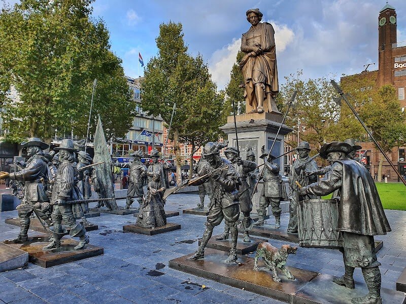 Rembrandt Monument - The Rembrandt Monument in Amsterdam is a captivating tribute to one of the world’s greatest artists, standing proudly at the heart of lively Rembrandtplein. Crafted in 1852 by sculptor Louis Royer, this bronze statue depicts Rembrandt van Rijn in a thoughtful pose, holding his painter’s palette and brushes—symbols of his enduring artistic genius. Families and curious travelers alike will find themselves drawn not only to the monument’s impressive detail, which reflects the fashion and spirit of the 17th century, but also to the vibrant atmosphere of the surrounding square, alive with cafés, street performers, and bustling crowds. What makes this monument truly special is its role as Amsterdam’s oldest surviving public statue, commemorating Rembrandt’s profound influence on art and culture. As evening falls, the interplay of light and shadow across the statue’s surface echoes the dramatic chiaroscuro technique that defined Rembrandt’s masterpieces, creating a magical ambiance for visitors. Here, you can pause for reflection, share stories with your family, and let your imagination wander through the city’s rich artistic heritage. The Rembrandt Monument is more than a landmark—it’s a place where history and creativity converge, inviting everyone to be inspired by Amsterdam’s timeless legacy.