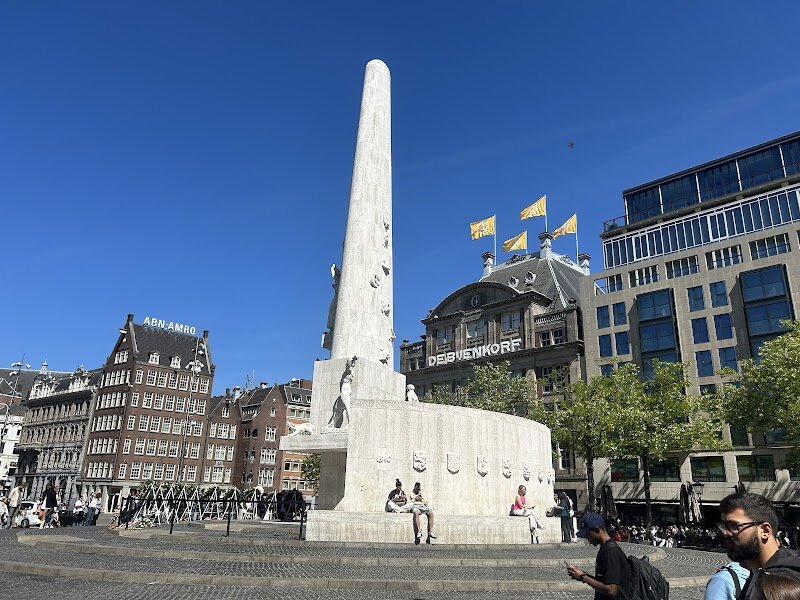 National Monument - In the heart of bustling Dam Square stands Amsterdam’s **National Monument**, a striking 22-meter obelisk that invites families and curious travelers to pause and reflect. Erected in 1956 and designed by renowned architect J.J.P. Oud, this white stone monument is the Netherlands’ most important memorial to the victims of World War II, honoring not only those lost but also the resilience of the Dutch people. What makes the National Monument truly special is its role as a living symbol of remembrance and unity. Every year on May 4th, the monument becomes the focal point of National Remembrance Day, drawing crowds—including the royal family—for a moving ceremony that connects past and present. Visitors are welcomed into a space where history is palpable: sculptures and inscriptions tell stories of freedom and peace, while the lively square all around reminds you that life continues, shaped by the sacrifices of those commemorated here. Whether you’re exploring with children or seeking a quiet moment amid the city’s energy, the National Monument offers a powerful, educational, and deeply human experience at the very heart of Amsterdam.