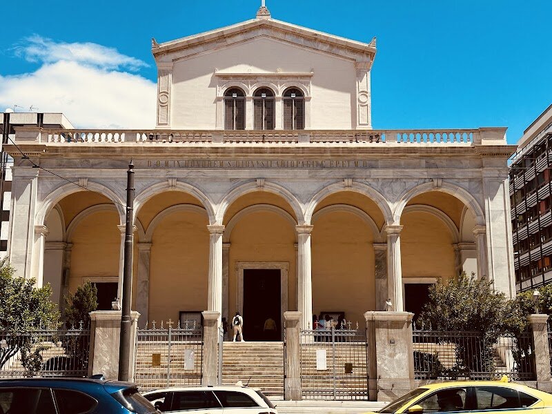 Holy Catholic Cathedral of Saint Denis the Areopagite - The Holy Catholic Cathedral of Saint Denis the Areopagite is a captivating blend of history, art, and spiritual warmth nestled in the heart of Athens. Built in the mid-19th century at the behest of King Otto and designed by renowned architects Leo von Klenze and Lysandros Kaftanzoglou, this neo-Renaissance basilica stands as the main Roman Catholic church of the city. Families and curious travelers will be enchanted by the cathedral’s luminous interior, adorned with stunning Italian marble, vibrant frescoes—like the dramatic *Apotheosis of Saint Dionysius the Areopagite*—and life-sized depictions of the four Evangelists. Beyond its architectural splendor, the cathedral is a living hub of community, offering masses in multiple languages and welcoming worshippers from around the world, including a thriving Filipino congregation. Visitors can marvel at the majestic pipe organ, Pentelic marble floors, and columns of green marble from Tinos, while soaking in the serene yet lively atmosphere. Whether you’re drawn by its rich history—marked by royal weddings and papal visits—or its inclusive spirit, the Cathedral of Saint Denis promises a memorable and uplifting experience for all ages.