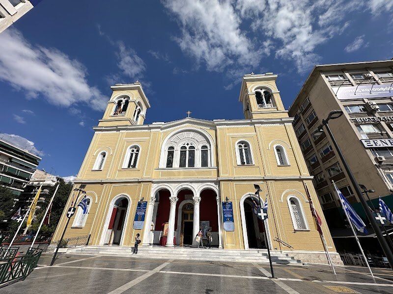 Ierós Mitropolitikós Naós Agíon Konstantínou & Elénis - Ierós Mitropolitikós Naós Agíon Konstantínou & Elénis stands as one of the most picturesque churches in Piraeus, inviting families and curious travelers to experience a unique blend of history, culture, and local life. Dedicated to Saints Constantine and Helen, this metropolitan church offers a window into the spiritual heart of Athens’ bustling port district. Its elegant architecture and serene atmosphere make it an ideal stop for those eager to explore beyond the city’s famous ancient ruins. Visitors can admire the church’s striking façade and step inside to find tranquil spaces adorned with traditional iconography, providing a glimpse into Greek Orthodox traditions. The church is often included in walking tours of Piraeus, where knowledgeable local guides share stories about the area’s rich past and the important role the church plays in community life. Families will appreciate the welcoming environment and the opportunity to learn about local customs, while travelers of all ages can enjoy the church’s peaceful setting amidst the lively streets of Piraeus. Whether you’re seeking cultural enrichment or simply a quiet moment in your day, Ierós Mitropolitikós Naós Agíon Konstantínou & Elénis offers a memorable experience in the heart of Athens’ port city.