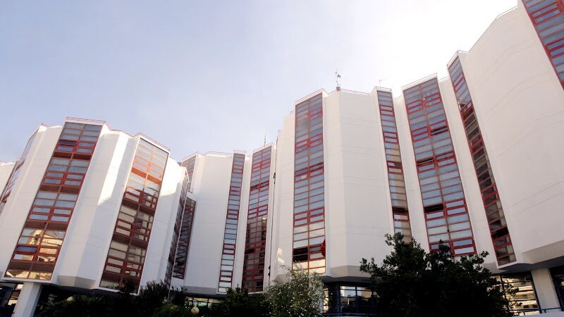 University of Piraeus - The University of Piraeus, nestled in the vibrant port city just southwest of Athens, is a fascinating blend of academic excellence and rich history. Founded in 1938 as a hub for business and industrial studies, it stands today as one of Greece’s premier universities, renowned for its focus on business, economics, finance, computer science, and maritime studies—the latter a fitting specialty in a city long shaped by the sea. What makes this university truly special is its unique location in Piraeus, a city that has served as Athens’ gateway to the world since ancient times. Visitors can stroll through neighborhoods where remnants of the legendary Long Walls stand, relics from the days when Piraeus was the bustling naval and commercial heart of classical Greece. The university’s campus pulses with youthful energy, international perspectives, and the spirit of innovation, making it a lively spot for families and curious travelers to experience modern Greek student life firsthand. A visit here is more than a tour of lecture halls; it’s a journey through history, with nearby museums, ancient ruins, and the iconic harbor just steps away. Whether you’re fascinated by Greece’s maritime legacy or eager to feel the city’s academic heartbeat, the University of Piraeus offers a memorable and enriching experience for all ages.