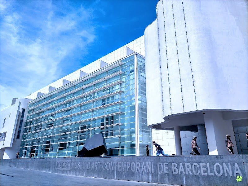 Museu d’Art Contemporani de Barcelona - Step into the Museu d’Art Contemporani de Barcelona (MACBA) and discover a vibrant hub where bold creativity meets the pulse of urban life. Nestled in the heart of the Raval neighborhood, MACBA stands out with its striking modernist design by renowned architect Richard Meier, whose gleaming white building has become an icon since its opening in 1995. The museum’s airy, light-filled spaces invite families and curious travelers to explore thought-provoking exhibitions that showcase art from the mid-20th century to today, featuring both local and international artists. MACBA isn’t just a museum—it’s a dynamic cultural center that has helped transform its neighborhood and foster a sense of community. Outside, the lively Plaça dels Àngels buzzes with skateboarders and street performers, adding to the museum’s reputation as a gathering place for creative expression and free-spirited fun. Inside, visitors of all ages can enjoy interactive displays, immersive installations, and educational programs designed to inspire curiosity and conversation. Whether you’re an art enthusiast or simply eager to experience Barcelona’s contemporary spirit, MACBA offers a welcoming space where imagination takes center stage.