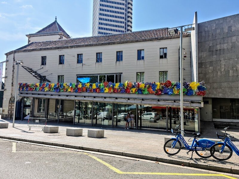 Santa Mònica - Santa Mònica in Barcelona is a vibrant fusion of history and contemporary creativity, perfectly situated at the lively southern end of La Rambla. Housed in a beautifully restored Renaissance building, this arts centre began life as a convent for the Augustinians in 1636, its classical cloister still echoing centuries of Barcelona’s story. Over time, the building has worn many hats—from military barracks to journalism school—before being transformed in 1988 into the city’s first public contemporary art centre. Families and curious travelers will find Santa Mònica especially inviting for its ever-changing exhibitions and hands-on activities, designed to spark imagination across all ages. The centre is renowned for hosting interactive installations, festivals, and workshops that encourage dialogue between art, science, and technology. The innovative exterior ramp doubles as an open-air balcony, offering panoramic views of bustling La Rambla—a perfect spot for kids and adults to soak in the city’s energy. Santa Mònica stands out as a dynamic laboratory of ideas, where the past and future of Barcelona’s culture meet. Whether you’re exploring avant-garde art or simply wandering through its historic cloister, this is a place where creativity is celebrated, and every visit feels like a discovery.