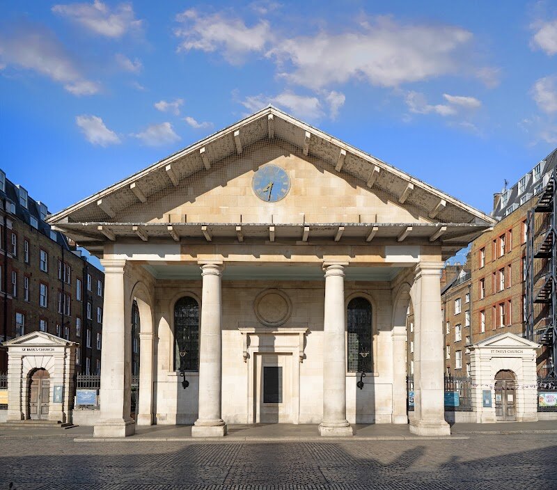 St Paul’s Church Covent Garden - Nestled in the lively heart of Covent Garden, **St Paul’s Church**—affectionately known as *The Actor’s Church*—offers families and curious travelers a unique blend of history and culture. Designed by the renowned architect Inigo Jones in 1631, it was commissioned by the 4th Earl of Bedford with the playful request for a building “not much better than a barn.” Jones responded with what he called “the finest barn in England,” creating a striking yet simple Tuscan-style church that stands out amid the bustling piazza. This church holds a special place in London’s story as the first purpose-built Anglican church since the Reformation. Its unusual layout—with the grand portico intended as the entrance but ultimately facing the altar—adds to its quirky charm. Known for its strong ties to the theater community, St Paul’s is a hub for performances, memorials, and events celebrating London’s dramatic arts. Visitors can stroll through the tranquil churchyard gardens, admire the elegant architecture, and perhaps catch a glimpse of a rehearsal or festival that brings the space to life. Whether you’re seeking a quiet escape or a window into London’s creative spirit, St Paul’s Church is a place where history and artistry meet in the heart of the city.