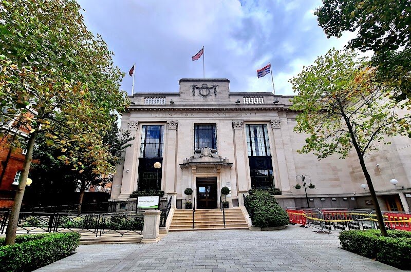 Islington Town Hall - Islington Town Hall is a striking landmark on Upper Street, blending the charm of English Baroque and Neoclassical styles in a way that’s both dignified and inviting. Built in the 1920s by architect E.C.P. Monson, this Grade II listed building stands out with its Portland stone façade, elegant portico, and a unique copper-clad clock turret—details that hint at its rich civic history. Stepping inside, visitors are greeted by opulent marble corridors, an imposing staircase, and lavishly decorated council chambers with carved oak paneling and plush red upholstery. Families and curious travelers will love exploring the grand interiors, which evoke the borough’s proud heritage and the spirit of local democracy. Islington Town Hall isn’t just about politics—it’s a living piece of history where community celebrations, weddings, and cultural events bring the halls to life. Children can marvel at the ornate ceilings, while adults appreciate the craftsmanship and stories embedded in its walls. Whether you’re a history buff, architecture lover, or just looking for a memorable stop in vibrant Islington, this town hall offers a fascinating glimpse into London’s civic past and present.