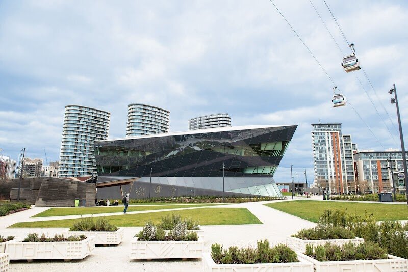 City Hall - London’s City Hall is a striking symbol of modern London, instantly recognizable for its futuristic, bulbous shape on the south bank of the Thames, right beside iconic Tower Bridge. Designed by renowned architect Norman Foster and opened in 2002, City Hall was conceived as the headquarters for the Mayor of London and the Greater London Authority, but it stands out for much more than its political role. Families and curious travelers will be fascinated by its unique ovoid design, which isn’t just for show—it was engineered to maximize energy efficiency and minimize environmental impact, reflecting London’s commitment to sustainability. Inside, a dramatic 500-meter helical walkway spirals up through the building, offering a sense of openness and transparency and providing visitors with ever-changing views of the city and the building’s interior. At the top, “London’s Living Room” is an exhibition and meeting space with an open viewing deck, occasionally accessible to the public, where you can enjoy sweeping panoramas of London’s skyline. As part of the vibrant More London development, City Hall is surrounded by lively public spaces and The Scoop amphitheatre, making it an inviting destination for all ages to explore, learn, and be inspired by the city’s blend of history and innovation.