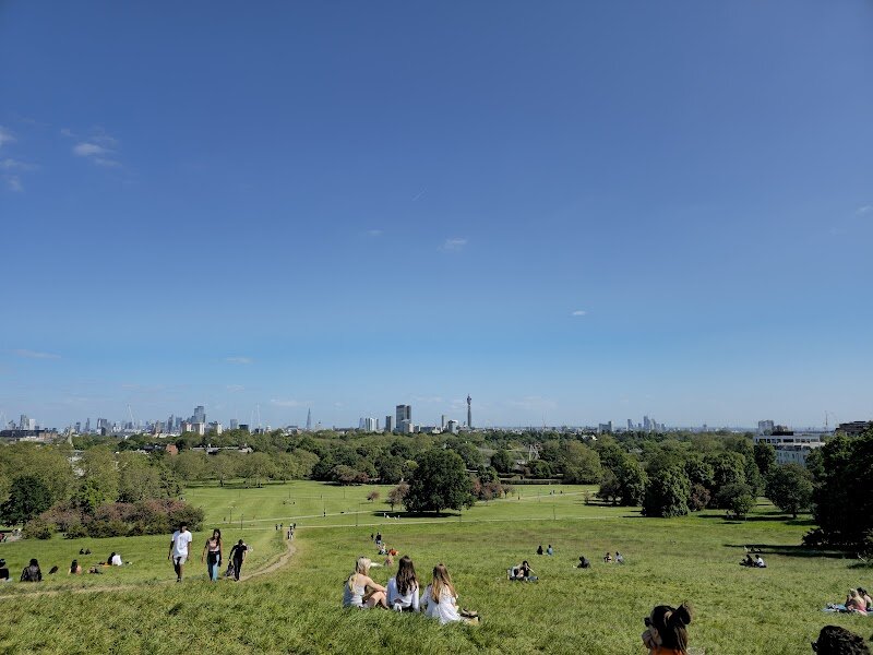 Primrose Hill - Primrose Hill is one of London’s most enchanting green spaces, offering families and curious travelers a perfect blend of history, beauty, and adventure. Rising gracefully to 63 meters, this gentle hill rewards visitors with sweeping 360-degree views of the city skyline—one of just six protected vistas in London—making it a favorite spot for picnics, kite flying, and memorable family photos. Steeped in history, Primrose Hill was once a dense forest teeming with wild animals, part of the royal hunting grounds for King Henry VIII. Over time, it transformed into open meadows, and by Elizabethan times, it was named for the primrose flowers that still bloom here each spring. The hill has witnessed fascinating chapters of London’s past, from royal hunts to mysterious 17th-century events and even legendary prophecies. Today, visitors can stroll along leafy paths, relax on grassy slopes, or wander through the surrounding neighborhood of pastel-hued Victorian terraces and charming cafés. Whether you're seeking a peaceful escape, a place for children to play, or simply a unique vantage point to admire London, Primrose Hill invites everyone to experience its timeless magic.