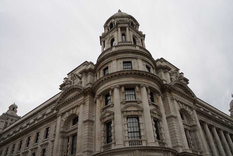 Old War Office Building - Step into the storied halls of the **Old War Office Building**, an iconic London landmark where the drama of history meets modern elegance. Originally completed in 1906, this grand neo-Baroque edifice was the nerve center for Britain’s military operations, orchestrating strategic decisions through two world wars and pivotal moments of the 20th century. Its imposing façade, crowned by four majestic domes and adorned with sculptures symbolizing Peace, War, Truth, and Victory, invites curious travelers and families to imagine the footsteps of generals, spies, and statesmen who once roamed its 1,100 rooms. Today, the building’s transformation into Raffles London at The OWO blends its historical gravitas with contemporary luxury, making it a must-see destination for those eager to connect with Britain’s past while enjoying world-class hospitality. Visitors can marvel at the intricate Edwardian architecture, explore grand corridors and richly detailed interiors, and soak in the atmosphere where the fate of nations was once decided. Whether you’re a history buff or simply seeking a memorable family experience, the Old War Office promises a journey through time in the very heart of London.