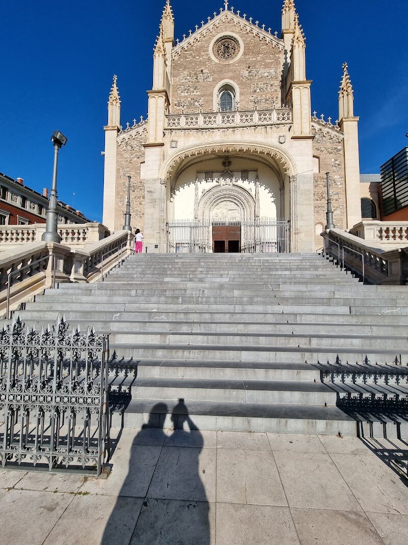 Iglesia de San Jerónimo el Real - The **Iglesia de San Jerónimo el Real** in Madrid is a captivating blend of history, art, and architecture that enchants families and curious travelers alike. Originally commissioned by the Catholic Monarchs in the early 1500s, this church was once a royal monastery where Spanish kings rested and important ceremonies like royal weddings and proclamations took place. Its stunning **Isabelline Gothic style**, infused with Renaissance touches, creates an evocative atmosphere that invites visitors to step back in time. Inside, visitors can admire groin-vaulted ceilings, intricately carved pillars, and beautiful altarpieces, including works lent by the nearby Prado Museum. The church’s exterior showcases elegant neo-Gothic towers added during 19th-century restorations, giving it a fairy-tale appearance that delights both adults and children. Adjacent is a serene Baroque cloister, perfect for a quiet moment of reflection after exploring Madrid’s bustling city center. Whether attending a mass, marveling at the architecture, or simply soaking in centuries of royal history, the Iglesia de San Jerónimo el Real offers a unique and welcoming experience for all ages, making it a must-see cultural gem in Madrid.