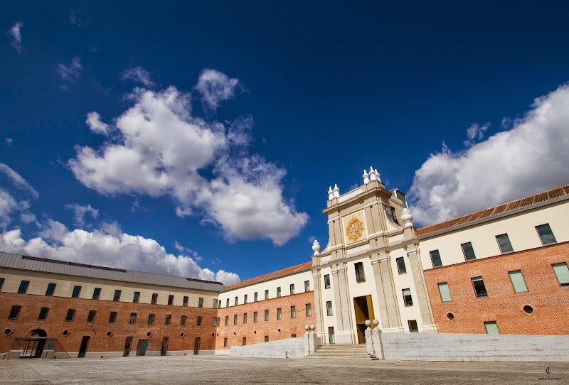Centro de Cultura Contemporánea Conde Duque - Step into the heart of Madrid’s vibrant cultural scene at the Centro de Cultura Contemporánea Conde Duque, a place where history and creativity come alive. Housed in a striking 18th-century former barracks, this grand pink-hued building once sheltered elite royal guards and echoed with the footsteps of soldiers. Today, it welcomes families, art lovers, and curious travelers with open arms, offering a dynamic mix of exhibitions, live performances, concerts, and workshops for all ages. Wander through its spacious halls and discover traces of its military past, from the Latin motto etched into the brickwork to the restored architectural details that whisper stories of centuries gone by. Inside, you’ll find everything from contemporary art shows and theatrical productions to a vast library and archives filled with treasures from Madrid’s rich history. Whether you’re exploring the archives, catching a show in the intimate theater, or simply soaking up the atmosphere in the sunlit courtyards, Conde Duque is a place where the past inspires the present. It’s not just a cultural center—it’s a living, breathing celebration of Madrid’s spirit, making it a must-visit for anyone eager to experience the city’s artistic soul.