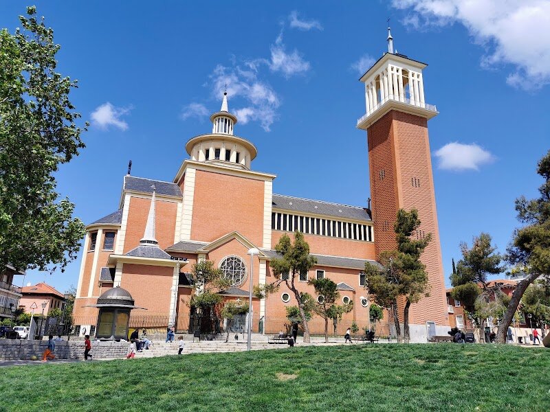 Santuario de Santa Gema - Santuario de Santa Gema stands as one of Madrid's most devotionally significant religious sites, built in 1953 and dedicated to Saint Gemma Galgani. This modern sanctuary has become a spiritual haven for pilgrims and visitors seeking peace and contemplation in the heart of the city. The sanctuary's distinctive architecture reflects the neo-Herrerian style characteristic of Francoist-era construction, with its striking red brick façade and graceful dome creating an impressive visual presence. Inside, visitors discover a serene atmosphere enhanced by beautiful stained glass windows that bathe the interior in colorful light. What truly sets this sanctuary apart is its role as custodian of an extraordinary relic—the heart of Saint Gemma has been housed here since 1985. On the 14th of every month, the sanctuary hosts solemn celebrations honoring this precious relic, drawing devoted followers from across Spain and beyond. The peaceful interior, combined with its complete souvenir shop, makes it an ideal destination for those seeking spiritual reflection or simply wishing to experience Madrid's rich religious heritage.