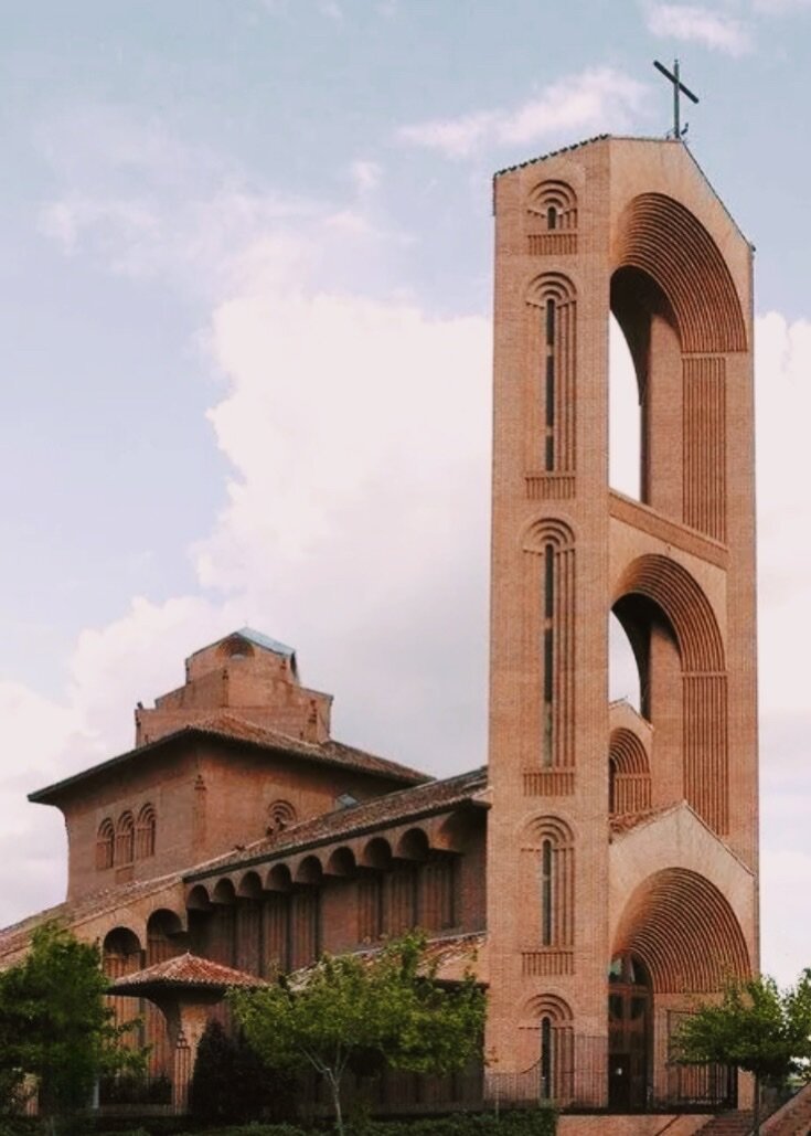 Parish St. Mary of Cana - # Discover the Modern Marvel of Iglesia de Santa María de Caná Nestled in Pozuelo de Alarcón, the Iglesia de Santa María de Caná stands as a striking testament to contemporary religious architecture. This Catholic parish church, completed in 1999 under architect Fernando Higueras' vision, transforms brick and light into something truly extraordinary. The church's most captivating feature is its soaring twenty-meter dome, which bathes the interior in natural light through expansive windows. The Greek cross layout creates four symmetrical wings radiating from a central altar, fostering an intimate yet spacious atmosphere perfect for community gatherings. The distinctive forty-meter tower rises prominently above the surrounding landscape, earning it local affection as "the Cathedral of Pozuelo". What makes this place special is how it balances grandeur with accessibility. The brick construction, with its thoughtful geometric patterns, creates visual interest at every angle. Beyond the main sanctuary, the complex includes multiple rooms beneath the temple, hosting various community activities. Whether you're an architecture enthusiast, a spiritual seeker, or simply curious about modern design, Santa María de Caná offers a refreshing perspective on how contemporary faith spaces can inspire and unite communities.