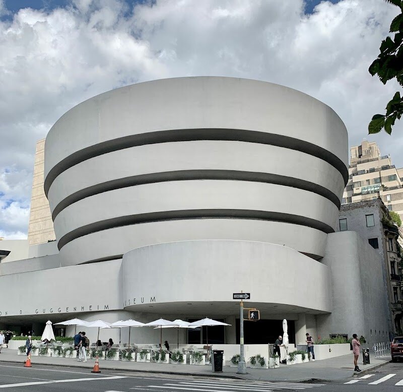 Solomon R. Guggenheim Museum - The **Solomon R. Guggenheim Museum** in New York is unlike any other museum you’ll visit—a true icon where art and architecture blend into one unforgettable adventure. Designed by the legendary Frank Lloyd Wright and opened in 1959, the Guggenheim’s sweeping white spiral stands out boldly against Manhattan’s sharp cityscape, making it a must-see for families and travelers eager for something extraordinary. Step inside, and you’re greeted by a soaring atrium crowned with a glass dome that floods the space with natural light. Instead of conventional galleries, the museum features a unique, gently sloping ramp that spirals upward for six stories, inviting visitors to experience world-class modern and contemporary art as a continuous journey rather than a series of separate rooms. Kids and adults alike will be captivated by the building itself, which feels more like exploring a giant sculpture than a traditional museum. Beyond its striking design, the Guggenheim hosts ever-changing exhibitions, interactive family programs, and masterpieces from artists like Kandinsky and Picasso. This is a place where curiosity thrives and every visit offers something new—an inspiring day out for art lovers and curious minds of all ages.