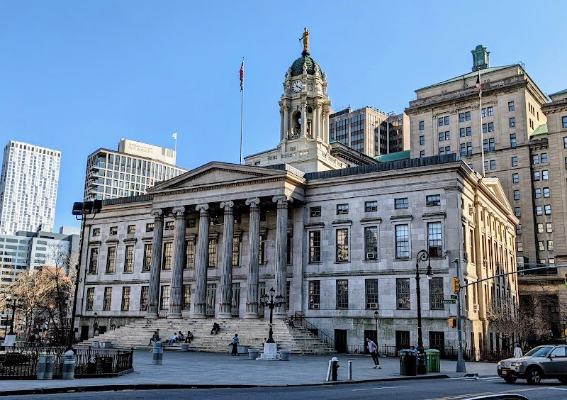 Brooklyn Borough Hall - Brooklyn Borough Hall stands as a grand gateway to Brooklyn’s past and present, inviting families and travelers to experience a living piece of New York history. Completed in 1851 and designed by Gamaliel King, this striking Greek Revival landmark is Brooklyn’s oldest public building and once served as the bustling heart of the city’s government before Brooklyn joined New York City in 1898. Its stately façade, with soaring Ionic columns and a domed cupola, makes it a favorite backdrop for photos and local gatherings. Step inside, and you’ll find more than just beautiful architecture. The lobby displays portraits of former mayors, offering a fascinating glimpse into Brooklyn’s civic legacy. Families can imagine the days when the building housed courtrooms, city offices, and even a jail—making it a hub of city life in the 19th century. Outside, the sweeping steps and lively plaza often host community events, making Borough Hall not just a historic site but a vibrant part of Brooklyn’s daily rhythm. Whether you’re a history buff, an architecture enthusiast, or simply curious, Brooklyn Borough Hall offers an engaging journey through time in the very heart of downtown Brooklyn.