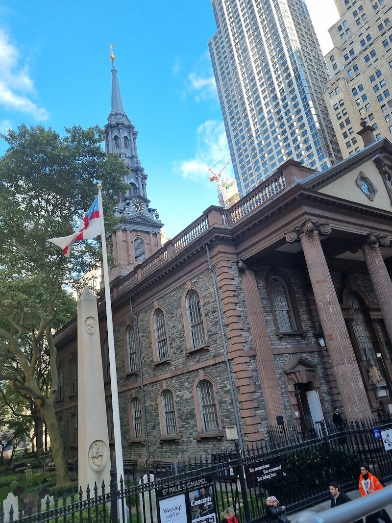 St. Paul's Chapel - St. Paul’s Chapel, nestled amid Lower Manhattan’s skyscrapers, is a living testament to New York City’s rich history and resilience. Built in 1766, it is **Manhattan’s oldest surviving church** and the only colonial-era church still standing on the island, making it a rare window into the city’s earliest days. Families and curious travelers will find themselves walking in the footsteps of George Washington, who worshipped here after his presidential inauguration in 1789—a moment you can still sense when viewing Washington’s pew and the stunning 18th-century architecture. What sets St. Paul’s apart isn’t just its age, but its unwavering presence during New York’s defining moments. The chapel famously survived the Great Fire of 1776 and, centuries later, stood unscathed beside Ground Zero on September 11th, becoming a sanctuary for recovery workers and a symbol of hope for the city. Today, visitors can explore moving memorials, marvel at original Georgian design, and enjoy free concerts and cultural programs in a space that has offered comfort and inspiration for over 250 years. Whether you’re seeking history, reflection, or a unique family adventure, St. Paul’s Chapel welcomes all who enter with stories of endurance and unity.