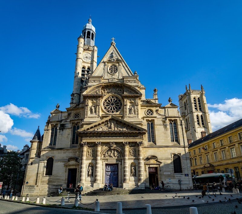 Church of Saint-Étienne-du-Mont - The Church of Saint-Étienne-du-Mont, nestled beside the Panthéon in Paris’s historic Latin Quarter, is a hidden gem that delights families and curious travelers alike with its captivating blend of history, art, and architecture. This remarkable church traces its origins back to the 6th century, when it stood alongside the ancient Abbey of Saint Geneviève, the burial place of Paris’s patron saint and early French royalty. What sets Saint-Étienne-du-Mont apart is its stunning architectural fusion: as you approach, the unique Renaissance façade—unlike anything else in Paris—rises in elegant tiers, crowned by a soaring bell tower and intricate sculptures. Inside, visitors are greeted by a luminous interior where Gothic arches meet Renaissance ornamentation, and sunlight filters through exquisite stained glass windows from the 16th and 17th centuries. Families will marvel at the church’s rare rood screen—the only one left in Paris—and can seek out the shrine of Sainte-Geneviève or the tombs of famed writers Pascal and Racine. Whether you’re drawn by centuries-old legends or breathtaking artistry, Saint-Étienne-du-Mont offers a journey through layers of French history and Parisian charm.