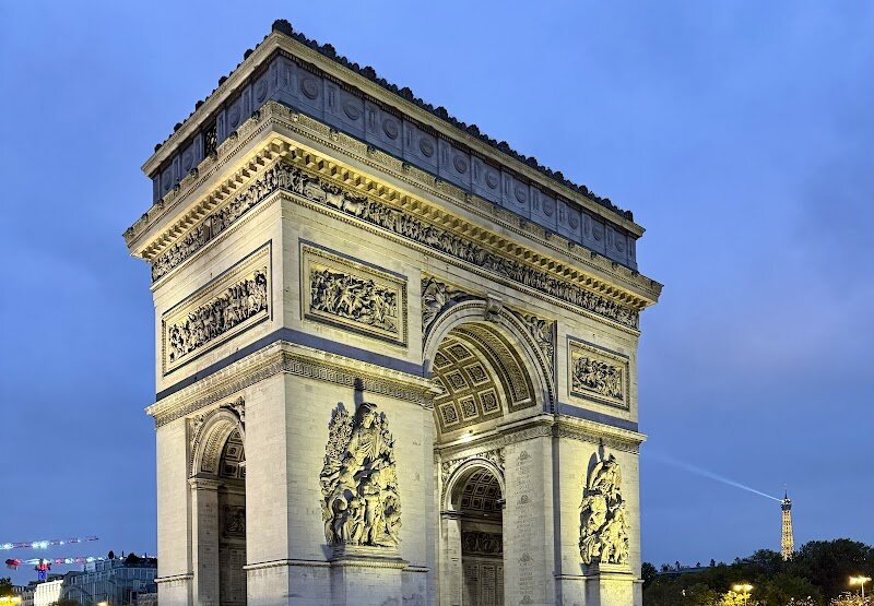 Arc de Triomphe - The **Arc de Triomphe** stands as one of Paris’s most iconic landmarks, captivating visitors with its grandeur and rich history. Commissioned by Napoleon in 1806 to honor the soldiers who fought and died for France during the French Revolutionary and Napoleonic Wars, this colossal monument is more than just an architectural marvel—it’s a symbol of national pride and remembrance. Rising over 160 feet at the heart of the bustling Place Charles de Gaulle, the Arc anchors a majestic circle of twelve avenues, offering a dramatic gateway to the famed Champs-Élysées. Families and curious travelers alike will be drawn to its intricate carvings, which immortalize the names of French victories and heroes. Beneath the arch lies the **Tomb of the Unknown Soldier**, a solemn tribute to those lost in World War I, marked by an eternal flame that invites reflection and respect. Take the opportunity to climb to the top, where panoramic views reveal the city’s sweeping boulevards and sparkling skyline—a favorite spot for memorable photos and shared moments. Whether you’re exploring its historical significance, marveling at its artistry, or simply soaking in the vibrant energy of Paris, the Arc de Triomphe promises a stirring experience at the crossroads of French history and culture.