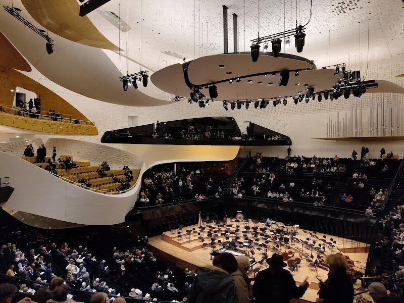 Cité de la Musique - Cité de la Musique in Paris is a vibrant cultural hub where music comes alive for visitors of all ages, nestled in the creative expanse of Parc de la Villette. Designed by renowned architect Christian de Portzamparc and inaugurated in 1995, this remarkable complex was born from a vision to open up the world of music, blending bold modern architecture with immersive artistic experiences. Step inside and you’ll find more than just concert halls—there’s a captivating music museum displaying treasures from centuries of musical history, interactive exhibits, and hands-on discovery zones that spark curiosity in both kids and adults. Families can enjoy live performances in the state-of-the-art concert hall, wander through luminous corridors, and explore lush gardens and patios woven into the building’s innovative design. What makes Cité de la Musique truly special is its celebration of all musical genres and its mission to make music accessible, whether you’re attending a world-class concert, joining a workshop, or simply exploring the enchanting spaces. It’s a place where history, creativity, and learning harmonize, inviting every curious traveler to experience the universal language of music in unforgettable ways.