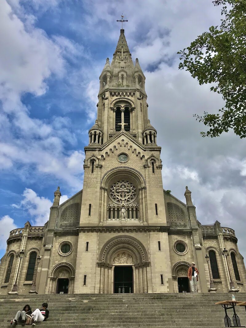 Catholic Church of Our Lady of the Cross of Ménilmontant - Nestled in the lively 20th arrondissement, the **Catholic Church of Our Lady of the Cross of Ménilmontant** is a hidden gem that invites families and curious travelers to discover Paris beyond its famous landmarks. Built between 1863 and 1880, this parish church is a striking blend of **neo-Romanesque and neo-Gothic architecture**, designed by renowned architect Antoine Héret. Its impressive façade, adorned with sculptural details and sweeping steps, creates a picturesque setting perfect for relaxing in the adjacent square. Stepping inside, visitors are greeted by a serene atmosphere and elegant arches that speak to the church’s rich history. The church played a unique role during the Paris Commune in 1871, serving as a gathering place for pioneering women’s clubs, adding layers of social and cultural significance to its spiritual heritage. Families will enjoy the chance to explore both the exterior’s intricate statues and the tranquil interior, while those with a passion for history can imagine the vibrant community life that has shaped this neighborhood for generations. A visit here offers a refreshing break from the crowds, a chance to appreciate authentic Parisian architecture, and a glimpse into the city’s dynamic past.