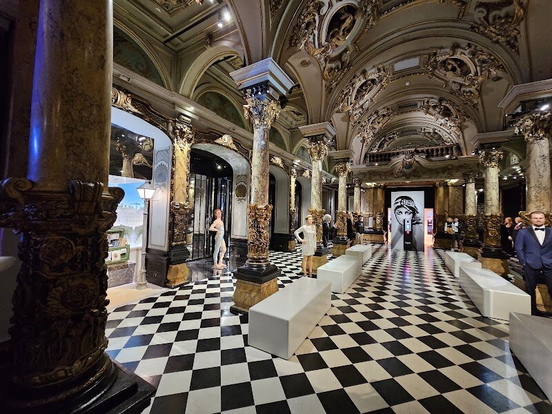 Musée Grévin - Step into the enchanting world of **Musée Grévin**, Paris’s celebrated wax museum where history, celebrity, and artistry come alive for visitors of all ages. Founded in 1882 by visionary journalist Arthur Meyer and brought to life by artist Alfred Grévin, this Belle Époque treasure was designed to give faces to the headlines, long before photography became widespread. Today, families and curious travelers can wander through dazzling galleries featuring over 400 lifelike wax figures—from French kings and revolutionaries to global icons like Marilyn Monroe, Queen Elizabeth II, and Ronaldo. Children and adults alike will marvel at the **interactive displays** and immersive scenes, which invite you to rub shoulders with movie stars, musicians, athletes, and world leaders. The museum’s ornate marble staircase and famous Hall of Mirrors, originally built for the 1900 Universal Exhibition, add a touch of magic and grandeur to every visit. With its unique blend of history, spectacle, and playful fun, Musée Grévin is a delightful Parisian experience that sparks curiosity and imagination—making it a must-see destination for families and adventure-seekers alike.