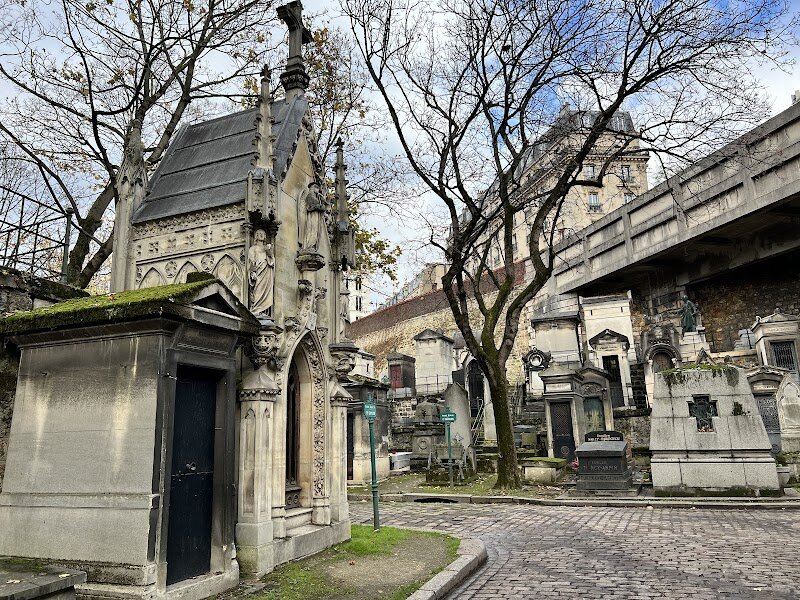 Cimetière de Montmartre - Cimetière de Montmartre is a hidden gem in the heart of Paris, inviting families and curious travelers to explore a peaceful oasis steeped in history and artistry. Opened in 1825 atop the site of an old gypsum quarry, this cemetery is more than a resting place—it’s a storybook of Parisian culture and creativity. As you wander its tree-lined paths, you’ll discover grand mausoleums, delicate statues, and the graves of luminaries like painter Edgar Degas, novelist Alexandre Dumas, and the legendary can-can dancer Louise Weber. What makes Montmartre Cemetery truly special is its unique blend of serenity and inspiration. The grounds are alive with the tales of artists, writers, and revolutionaries who shaped Paris, offering an engaging way for families to connect with the city’s vibrant past. Children may be delighted to spot the friendly stray cats that have made the cemetery their home, while adults can appreciate the fascinating mix of architectural styles and the tranquil atmosphere away from busy streets. A stroll here is like stepping into a living museum—perfect for those seeking a quiet adventure, a dose of history, and a touch of Parisian magic all in one memorable visit.