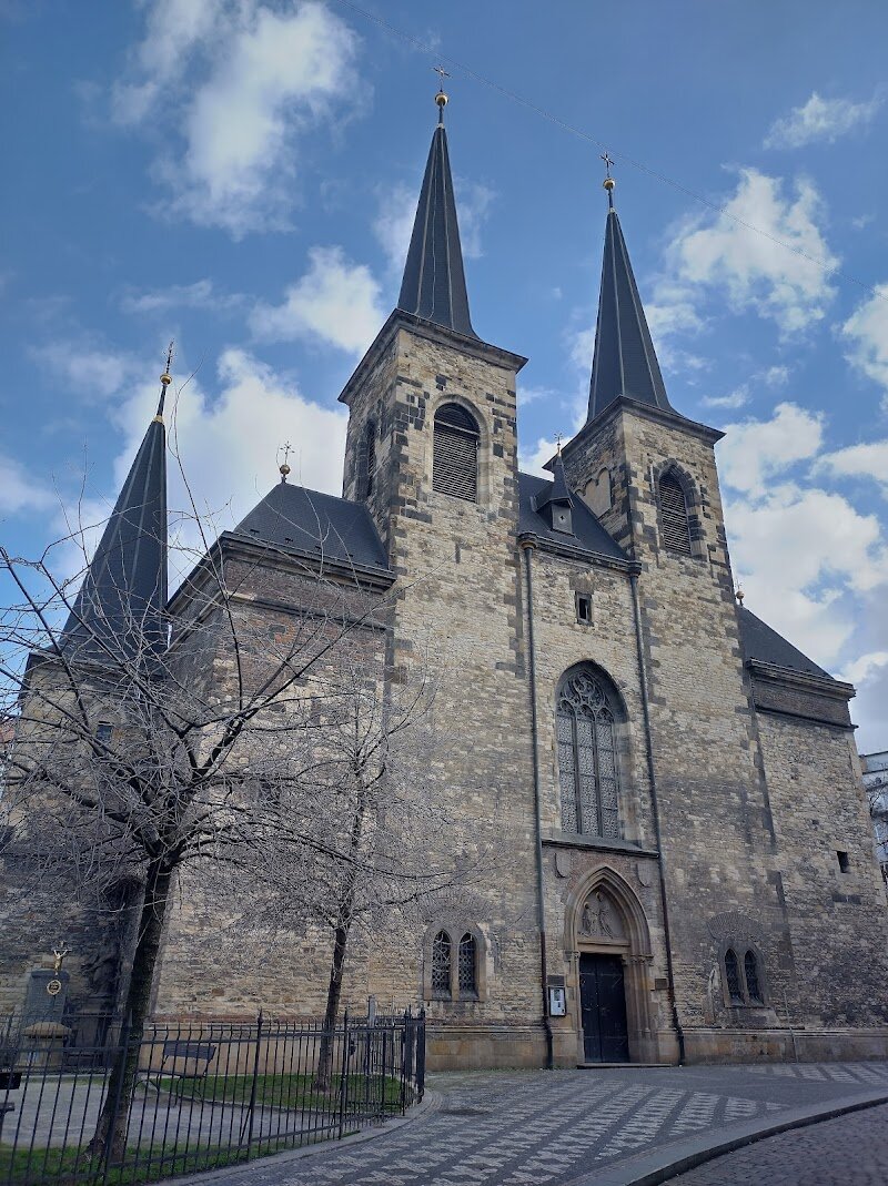 St. Peter at Poříčí - St. Peter at Poříčí in Prague is a captivating blend of history and architectural beauty, inviting families and curious travelers to step into a story that spans nearly a thousand years. Nestled in the vibrant New Town, this Romanesque basilica was originally built in the mid-12th century for the settlement of Poříčí, once a bustling riverside community of merchants and knights. As you enter, you’ll be greeted by a harmonious mix of Romanesque, Gothic, and Baroque elements—each layer reflecting the church’s resilience through fires, wars, and centuries of change. Children and adults alike will marvel at the church’s striking stonework, soaring arches, and intricate stained glass, all lovingly restored to showcase its medieval roots. The site’s fascinating past comes alive as you discover stories of knights, royal patrons, and dramatic sieges, making it a perfect setting for young imaginations and history enthusiasts. Beyond its history, the peaceful interior offers a quiet escape from the city’s bustle, while the surrounding streets still hint at the old Poříčí, where merchants once traded along the Vltava. A visit to St. Peter at Poříčí is not just a step into a church, but a journey into the living heart of Prague’s past and present.