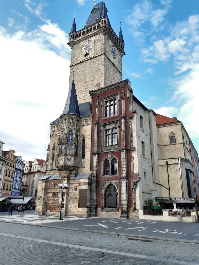 Staroměstská radnice - Staroměstská radnice, Prague’s Old Town Hall, is a place where history and wonder come alive for families and curious travelers. Rising proudly from the heart of Old Town Square, this complex of ancient houses—dating back to 1338—has witnessed centuries of Prague’s most dramatic moments. Its striking Gothic tower, once the tallest in medieval Prague, offers panoramic views over a fairytale cityscape of red rooftops and spires—an experience children and adults alike will treasure. Step inside and you’ll discover labyrinthine cellars, elegant halls, and architectural details that reflect the city’s vibrant past, from Romanesque foundations to Renaissance windows. The real crowd-pleaser is the legendary Astronomical Clock, or Orloj, whose hourly show of mechanical apostles and whimsical figures delights all ages and sparks curiosity about medieval science and artistry. Beyond the clock, visitors can explore engaging exhibitions about Prague’s governance and history, or simply soak up the lively atmosphere of the surrounding square, bustling with street performers and cozy cafés. Staroměstská radnice isn’t just a building—it’s a gateway to Prague’s stories, making every visit a memorable adventure for families and explorers.