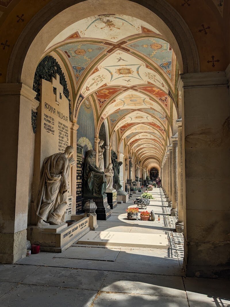 Vyšehrad Cemetery - Vyšehrad Cemetery, nestled beside the majestic Basilica of Saints Peter and Paul atop Prague’s historic Vyšehrad hill, is much more than a burial ground—it’s a vibrant tapestry of Czech history and culture. Families and curious travelers alike will find themselves captivated by its serene paths, lined with ornate neo-Renaissance arcades and artistically crafted tombstones from some of the nation’s finest sculptors and architects. What makes Vyšehrad Cemetery truly special is its role as the **national pantheon**—the final resting place for over 600 of Czechia’s most celebrated figures, from legendary composers like Antonín Dvořák and Bedřich Smetana to iconic writers such as Karel Čapek and Božena Němcová. The centerpiece, the grand Slavín tomb, stands as a powerful symbol of Czech pride, honoring those whose achievements have shaped the country’s identity. As you wander through its tranquil grounds, you’ll encounter fascinating memorials—like the white skis marking Josef Rössler-Ořovský’s grave, a pioneer of Czech sports—each telling a unique story. Vyšehrad Cemetery invites you to reflect on history, art, and the enduring spirit of a nation, making it a memorable stop for visitors of all ages.