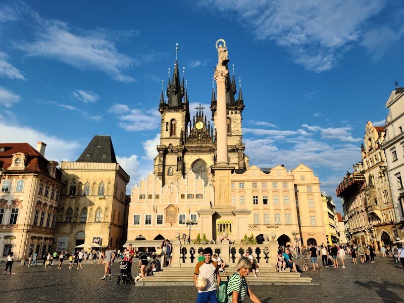 Old Town Square - Old Town Square in Prague is a captivating crossroads where centuries of history meet lively modern-day culture, making it an unforgettable destination for families and curious travelers alike. Established as a bustling marketplace in the 10th century, this iconic square has witnessed the rise and fall of kings, dramatic medieval events, and vibrant European trade. Today, visitors are surrounded by a breathtaking tapestry of Gothic, Baroque, and Romanesque architecture, including the legendary twin spires of the Church of Our Lady before Týn and the ornate St. Nicholas Church. Children and adults alike will be mesmerized by the Astronomical Clock, which springs to life every hour with its whimsical procession of figures—a spectacle that delights all ages. The square’s open spaces buzz year-round with street performers, festive markets, and outdoor cafés, providing endless opportunities to soak in the atmosphere or enjoy a treat together. Historical monuments, such as the Jan Hus Memorial and commemorative stones, invite visitors to uncover stories of courage and intrigue from Prague’s storied past. Whether you’re exploring underground dungeons, attending a classical concert, or simply watching the world go by, Old Town Square promises a magical blend of adventure, learning, and old-world charm for every traveler.