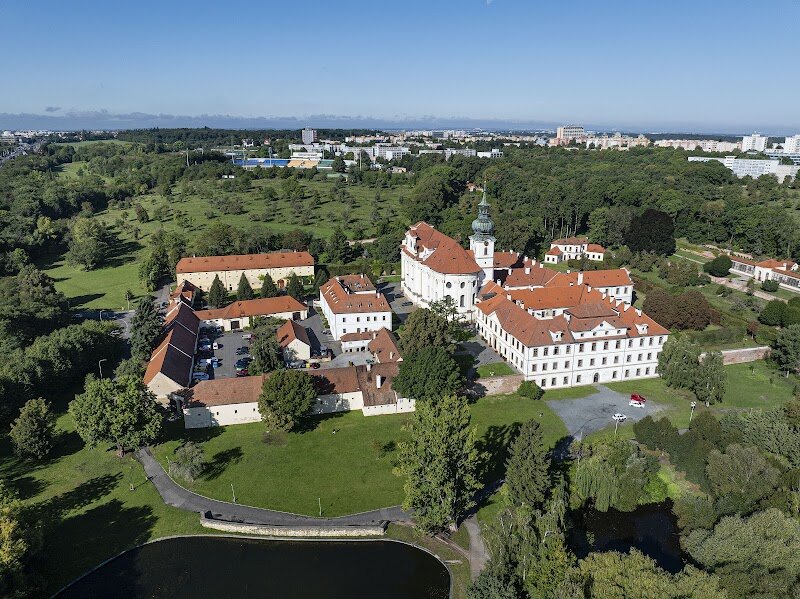 Břevnov Monastery - Břevnov Monastery, nestled in the tranquil outskirts of Prague, is a hidden gem brimming with stories that stretch back over a millennium. Founded in 993 by Prince Boleslaus II and Saint Adalbert, it holds the distinction of being the **oldest male monastery in Bohemia**, making it a place where history and legend intertwine. Over the centuries, this Benedictine haven has weathered wars, witnessed royal visits, and served as a spiritual and cultural anchor for the region. Families and curious travelers will delight in exploring the **stunning Baroque architecture**, wandering through peaceful gardens, and discovering treasures like the **Basilica of St. Margaret**—home to beautiful frescoes and a centuries-old crypt. The monastery’s library, filled with ancient manuscripts, sparks the imagination of all who visit. For a unique treat, sample traditional Czech beer brewed right on site, continuing a monastic brewing tradition dating back to the 13th century. With its blend of serene beauty, vibrant history, and family-friendly experiences, Břevnov Monastery offers a memorable journey through Prague’s past—perfect for those eager to combine learning with leisure in an enchanting setting.