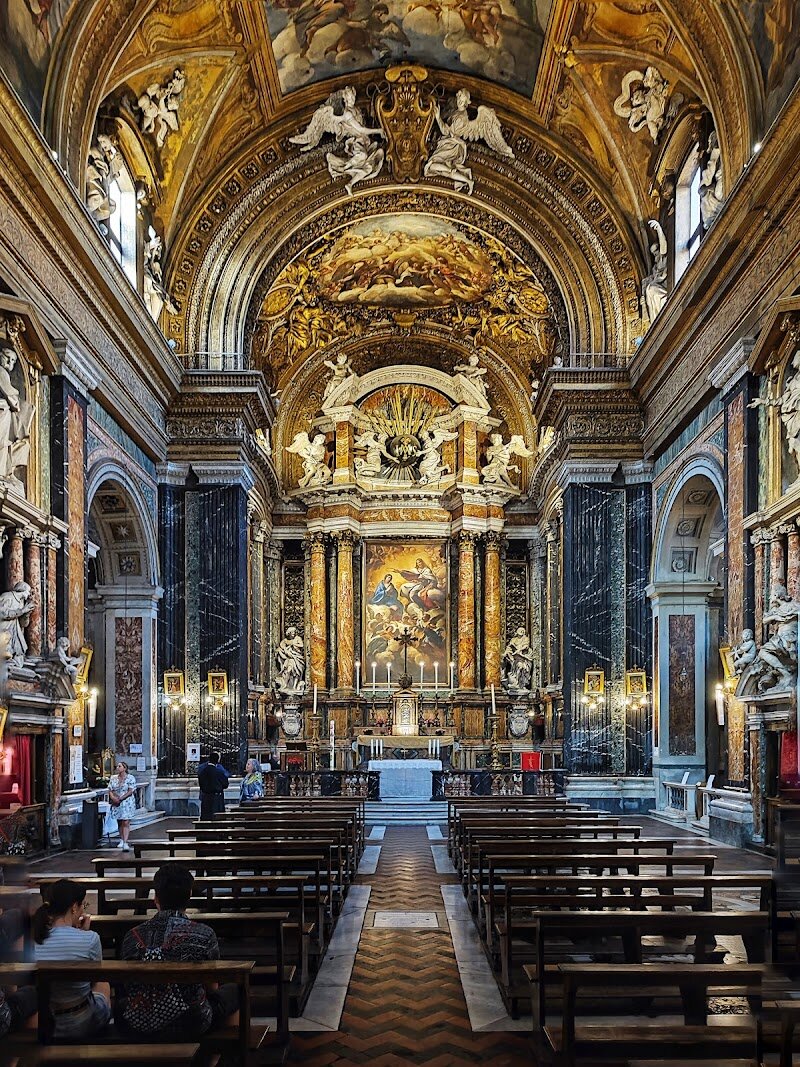 Church of Jesus and Mary - Step into the heart of Rome and discover the **Church of Jesus and Mary (Chiesa dei Santi Nomi di Gesù e Maria)**, a hidden Baroque treasure on the bustling Via del Corso. This enchanting church, completed in 1635, invites families and curious travelers to experience the splendor of Rome’s artistic and spiritual heritage. Its story begins with the Discalced Augustinians, who commissioned the elegant design by Carlo Buzio, later enhanced by Carlo Rainaldi’s refined travertine facade and lavish marble interiors. Inside, visitors are greeted by ornate Baroque décor—gleaming marble, intricate altars, and dramatic artistry that captivates both young and old. The church’s rich history includes periods under the Jesuit order and patronage from influential Roman families, reflecting centuries of devotion and artistry. Children and adults alike will marvel at the interplay of light on gilded surfaces and the peaceful atmosphere perfect for quiet reflection or family exploration. What makes this church truly special is its ability to transport visitors back to 17th-century Rome, offering a vivid glimpse into the city’s cultural and religious evolution. Whether you’re seeking inspiration, beauty, or a memorable moment together, the Church of Jesus and Mary promises an experience as timeless as the Eternal City itself.