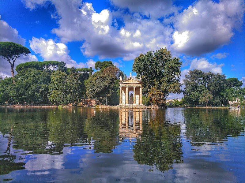 Villa Borghese - Nestled in the heart of Rome, Villa Borghese offers an enchanting escape where centuries of art and nature intertwine in perfect harmony. This magnificent estate began as the private playground of Cardinal Scipione Borghese in 1605, who dreamed of creating a cultural treasure that would rival Europe's grandest palaces. Today, this sprawling park welcomes visitors to wander through **English-style gardens** adorned with romantic fountains, hidden temples, and picturesque ponds. The jewel in its crown is the world-renowned Galleria Borghese, where masterpieces by Caravaggio, Bernini, and Raphael await discovery. Imagine standing before Bernini's breathtaking "Apollo and Daphne" or Caravaggio's dramatic "David with the Head of Goliath"—works that have captivated art lovers for centuries. Families will delight in the park's peaceful groves and open spaces, perfect for afternoon picnics and leisurely strolls. The gardens themselves tell stories of papal power, artistic passion, and the Borghese family's determination to create something extraordinary. Whether you're an art enthusiast, history buff, or simply seeking tranquility amid Rome's bustle, Villa Borghese offers an unforgettable journey through Italy's cultural soul.