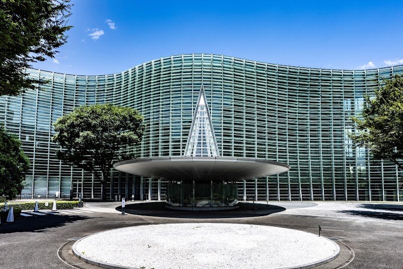 The National Art Center, Tokyo - The National Art Center, Tokyo stands out as one of the city’s most imaginative and family-friendly destinations for art lovers and curious travelers alike. Opened in 2007 on the former site of the University of Tokyo’s Institute of Industrial Science, this landmark was the final masterpiece of famed architect Kisho Kurokawa, whose iconic wave-like glass façade and airy, light-filled spaces make the building itself a work of art. What truly sets the Center apart is its innovative approach—unlike traditional museums, it has no permanent collection. Instead, it offers one of Japan’s largest exhibition spaces, hosting a vibrant rotation of temporary exhibitions spanning classic masterpieces, contemporary art, manga, fashion, and more. Every visit promises something new to discover, making it perfect for families seeking fresh experiences. Beyond the galleries, visitors can enjoy hands-on workshops, engaging educational programs, and lively artist talks designed to inspire all ages. The Center’s inviting cafés, including the renowned Salon de Thé ROND featured in the film *Your Name*, and the elegant Paul Bocuse restaurant, offer relaxing spots to reflect on your visit. At the National Art Center, Tokyo, art becomes a living, ever-changing adventure for everyone.