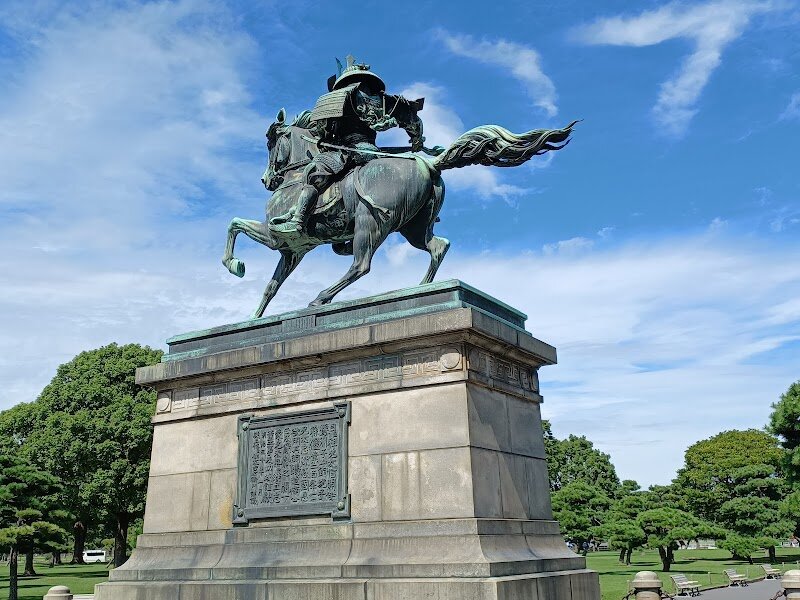 Statue of Kusunoki Masashige - The **Statue of Kusunoki Masashige** stands proudly near Tokyo’s Imperial Palace, capturing the imagination of families and history lovers alike. Cast in pure bronze and completed in 1900, this dramatic monument honors Kusunoki Masashige, a legendary 14th-century samurai famed for his unwavering loyalty and strategic brilliance. Masashige’s story is one of courage and sacrifice: he supported Emperor Go-Daigo in a turbulent era, ultimately giving his life in a last stand that would enshrine him as a symbol of honor and devotion in Japanese culture. Visitors are greeted by the powerful image of Masashige astride his horse, clad in detailed armor, gazing toward the palace as if still awaiting the emperor’s return. The statue’s craftsmanship is remarkable—each feature, from the warrior’s resolute expression to the horse’s lifelike stance, was meticulously researched and cast using innovative techniques for its time. Families and curious travelers will enjoy exploring the surrounding gardens, snapping memorable photos, and sharing the tale of a samurai whose spirit still inspires Japan today. The statue is not just a photo spot—it’s a gateway to centuries of history, inviting everyone to step into the world of samurai legends.