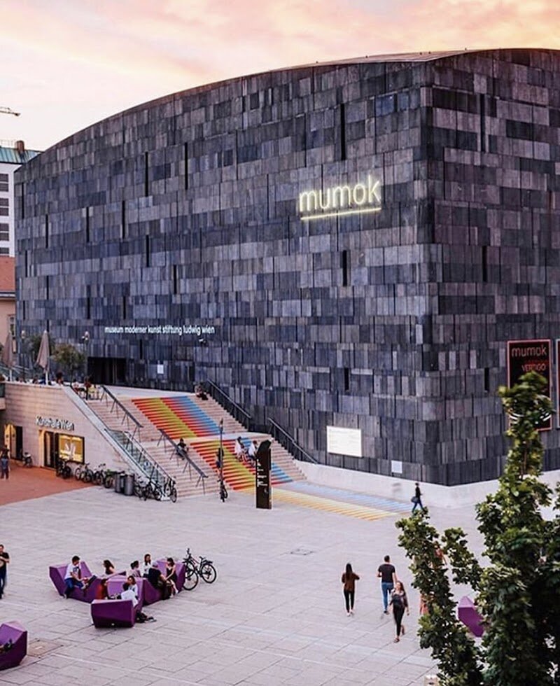 mumok - Museum moderner Kunst Stiftung Ludwig Wien - Discover mumok – Museum moderner Kunst Stiftung Ludwig Wien, one of Europe's leading museums dedicated to modern and contemporary art. Located in Vienna's vibrant MuseumsQuartier, this striking black basalt building designed by Ortner & Ortner houses an extraordinary collection of around 10,000 works spanning the 20th and 21st centuries. The museum's story is as fascinating as its collections. Born from a unique partnership between German collectors Peter and Irene Ludwig and the Austrian government in 1981, mumok transformed Vienna's art scene by making contemporary art central to public collections. This visionary collaboration brought together masterpieces of Pop Art, Photorealism, and avant-garde movements from the 1960s and 1970s, alongside classical modernism and Vienna Actionism. Today, mumok offers something for everyone—from families exploring contemporary photography, video, and installations to art enthusiasts diving deep into international modernist movements. Whether you're captivated by groundbreaking sculptures, immersive exhibitions, or thought-provoking contemporary pieces, mumok provides an inspiring journey through artistic innovation that continues to shape how we understand modern art.