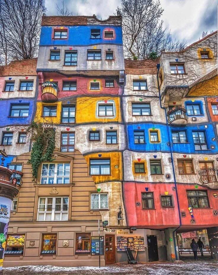 Hundertwasser House - Step into a world where imagination runs wild at Vienna’s Hundertwasser House—a true architectural fairytale that feels like it’s sprung from a storybook. Designed by the visionary artist Friedensreich Hundertwasser and completed in 1985, this colorful apartment building is anything but ordinary. With its wavy floors, crooked walls, and windows that are all uniquely shaped, every corner invites you to look closer and wonder. Trees grow right out of the balconies, their branches reaching skyward, while vibrant mosaics and glazed domes add a playful touch that delights both kids and adults. Hundertwasser dreamed of a “house for human beings and trees,” and here, nature and architecture live in joyful harmony. The building was a bold statement against the rigid, straight-lined modernism of its time, and today it stands as a symbol of creativity and individuality in the heart of Vienna. Families will love exploring the maze-like terraces and discovering the quirky details around every turn. Whether you’re an art lover, a curious traveler, or just looking for something wonderfully different, the Hundertwasser House promises a memorable experience that sparks the imagination and celebrates the beauty of the unexpected.