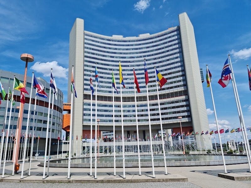 Vienna International Centre (VIC) - The Vienna International Centre, affectionately known as "UNO City," stands as a striking testament to modern architecture and international diplomacy in the heart of Europe. Designed by Austrian architect Johann Staber and completed in 1979, this gleaming complex features six distinctive Y-shaped office towers surrounding a cylindrical conference building, creating an ingenious ensemble that has captivated visitors for decades. What makes the VIC truly special is its unique character—it occupies inviolable international territory belonging to 193 UN member states, making it a fascinating microcosm of global cooperation. The silvery towers with their bold orange accents evoke the optimism of the 1970s, while the original furnishings transport you back in time. Visitors can explore interconnected office buildings, discover hidden corners, and ascend to interpreter booths offering panoramic views. The complex houses not just administrative spaces but also a medical centre, library, restaurants, and cafeteria, creating a self-contained international hub. Guided tours reveal the architecture's clever design and the inspiring work of thousands of UN employees from over 125 countries dedicated to improving lives worldwide. It's where history meets modernity in one compelling destination.