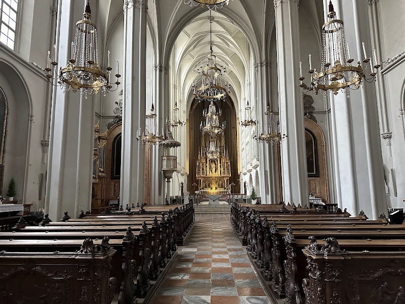 Augustinerkirche - Step inside Vienna’s Augustinerkirche and discover a hidden gem steeped in imperial history and quiet grandeur. Tucked beside the grand Hofburg Palace, this unassuming church has been a silent witness to centuries of Habsburg drama, from royal weddings to solemn farewells. Built in the 14th century, its soaring Gothic nave and elegant proportions create a sense of peace and awe, while the vibrant high altar and restored painted ceiling add splashes of color and artistry. What truly sets the Augustinerkirche apart is its unique connection to the Habsburgs. Behind a wrought iron gate, the Loreto Chapel houses the “Vault of Hearts,” where silver urns hold the hearts of emperors and empresses—a touching, intimate glimpse into royal tradition. As you wander through the church, you’ll feel the echoes of history: the footsteps of emperors, the whispers of prayers, and the legacy of Vienna’s most powerful dynasty. Whether you’re drawn to architecture, history, or simply the magic of old Vienna, the Augustinerkirche offers a memorable experience for families and curious travelers alike.