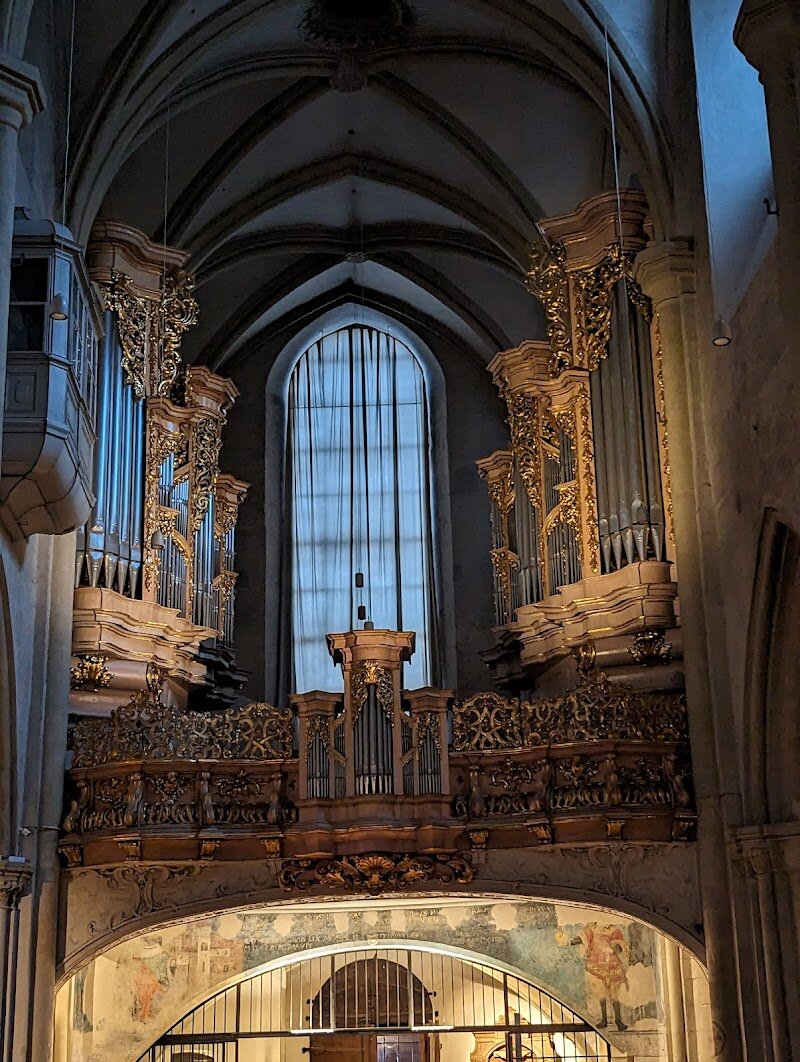 St. Michael's Church - St. Michael's Church stands as one of Vienna's most captivating architectural treasures, offering visitors a remarkable journey through eight centuries of history. Located at the entrance of the magnificent Hofburg Palace, this stunning church began its life around 1220 as a Romanesque structure, then evolved dramatically through successive centuries. What makes Michaelerkirche truly special is its architectural diversity—walking through its doors, you'll encounter a fascinating blend of Romanesque, Gothic, and Baroque styles layered throughout the interior and exterior. The church's pristine white facade contrasts beautifully with ornate details, while the soaring Gothic vaulting overhead creates an awe-inspiring atmosphere. Inside, each chapel and altar tells its own story. You'll discover everything from a bricked-up original portal from 1220 to an opulent high altar from the 1780s depicting Archangel Michael's triumph over Lucifer. The church's crypt once served as an imperial burial place, adding to its historical significance. For curious travelers and families alike, Michaelerkirche offers an almost overwhelming sense of lived history—a place where you can literally watch centuries unfold before your eyes, making it an unforgettable Viennese experience.