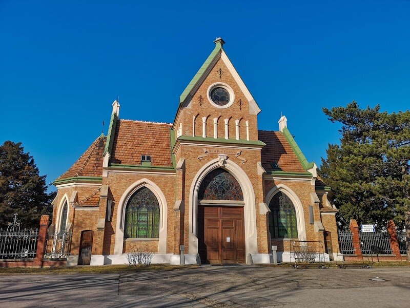 Stammersdorfer Zentralfriedhof - # Stammersdorfer Zentralfriedhof: Vienna's Hidden Cemetery Gem Nestled in Vienna's 21st district, the Stammersdorfer Zentralfriedhof stands as one of the city's most captivating historical sites. Consecrated on May 27, 1903, this sprawling 192,970-square-meter cemetery emerged from the vision of four neighboring communities seeking a unified burial solution. Designed by architects Oskar Mratschek and Karl Frömmel, the cemetery quickly became Vienna's second most important burial ground after the Central Cemetery. What makes this place truly special is its remarkable blend of history and tranquility. The grounds hold approximately 23,000 graves, including honorary resting places dedicated to notable figures who shaped Austrian culture. As you wander through its lush pathways, you'll discover the neogothic Aufbahrungshalle (chapel) at the main entrance and encounter the layered stories of Vienna's diverse communities. Beyond its historical significance, Stammersdorfer Zentralfriedhof offers visitors an intimate glimpse into Viennese traditions and cultural heritage. It's a peaceful sanctuary where families can reflect on history while experiencing the timeless beauty that defines Vienna's relationship with remembrance and respect.